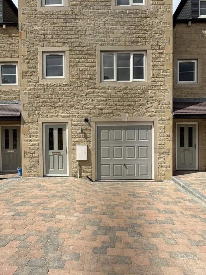Front door and garage door sprayed Agate Grey (RAL 7038) on a stone house