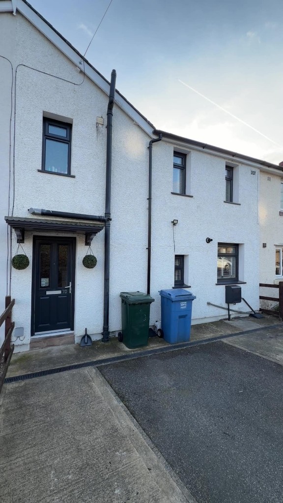 Anthracite windows, door and rainwater goods on a white rendered house