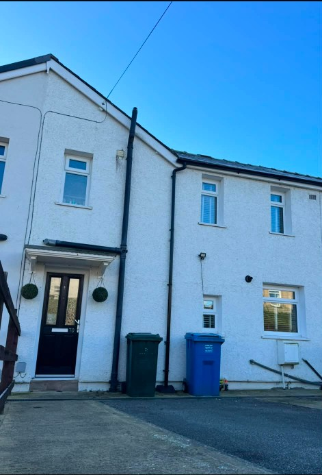 White windows and door on house number 70 before spraying