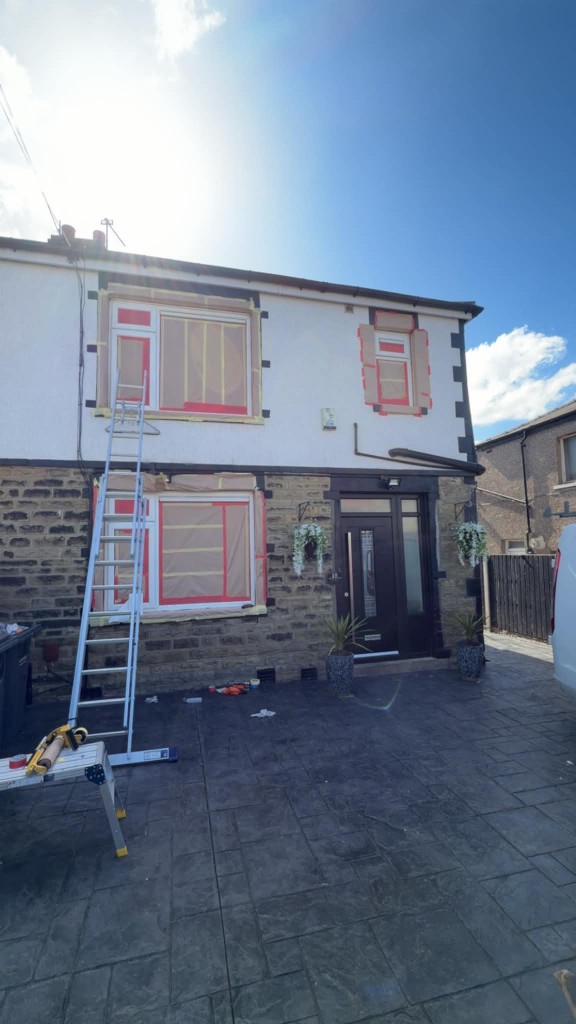 Windows fully masked with paper and tape before spraying